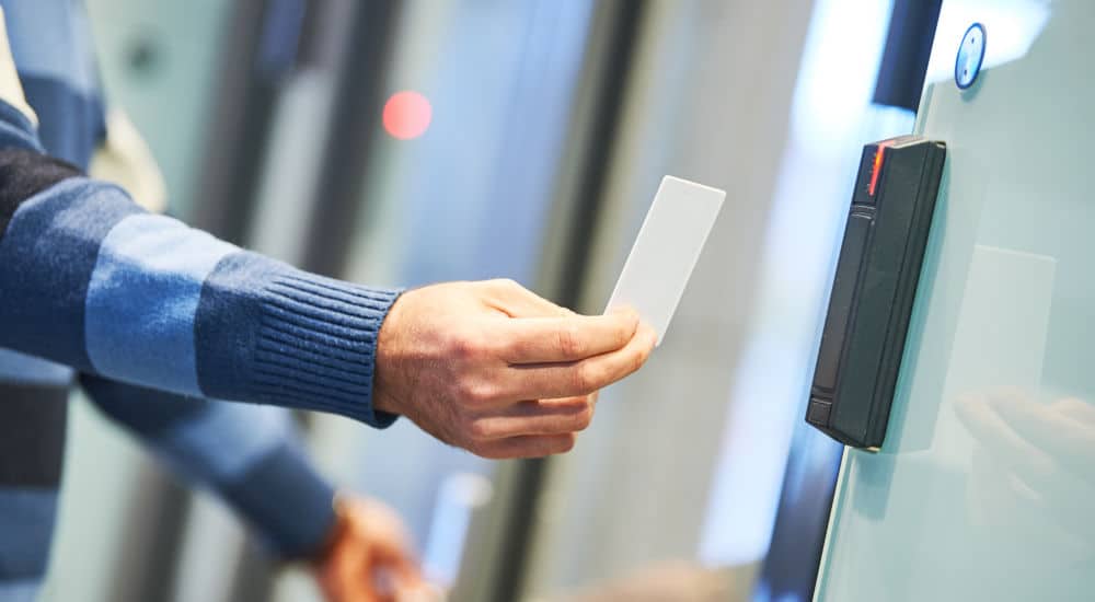 Employee using their ID card at the door access control system