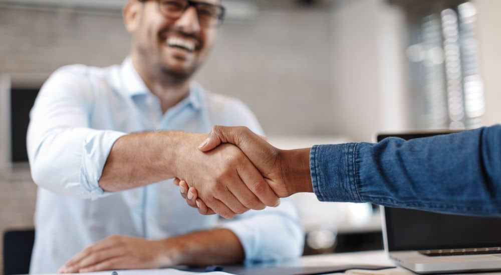 Sale representative shaking hands with a client